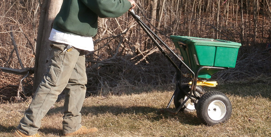 Lawn Care - Worker doing lawn aeration in early spring